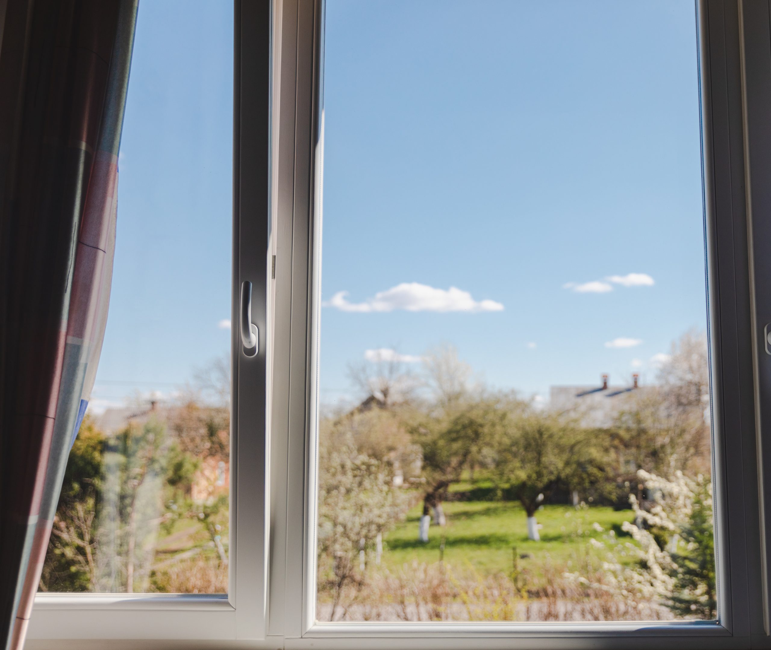 Timber double glazed window with a right-hand side 'fixed glazed panel' and a left side 'Tilt & Turn' sash in an open tilt-position."